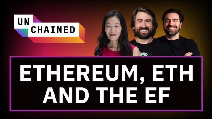 The image features a poster for an event titled "Unchained" with three people standing behind it, smiling at the camera. The text on the poster reads "Unchained", "Ethereum, Eth and the Ef", and "The EF is shrinking. Researchers are leaving. Vitalik says ETH is  the most high-value product".