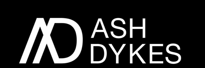 The image displays a banner featuring a stylized "AD" monogram logo alongside the text "ASH DYKES" in white against a black background. This appears to be the official logo or branding associated with the Solana token $PROJECT 6 on Moby, likely representing an explorer, athlete, or brand called Ash Dykes.