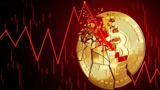 A graphic showing a cracked and shattering gold Bitcoin against a dark red background with a jagged red downward stock market chart line.