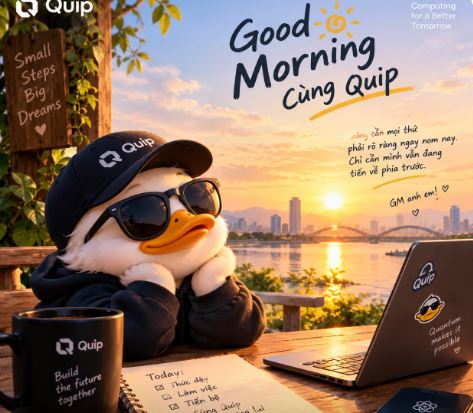 An illustrated cartoon duck wearing a black cap and sunglasses works on a laptop at a table overlooking a sunrise cityscape, promoting 'Good Morning cùng Quip' with Vietnamese text and a Quip-branded mug.