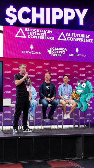 A panel discussion at the Canada Crypto Week / ETH Toronto Blockchain Futurist Conference with four people seated on stage and one standing with a microphone.