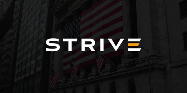 The image shows a darkened view of what appears to be the New York Stock Exchange building, with the American flag draped prominently across its facade and the word "STRIVE" overlaid in bold white text with an orange accent. This visual ties to the post about Strive, a corporate entity, accumulating Bitcoin—evoking institutional finance and the traditional financial system embracing crypto as an asset class.