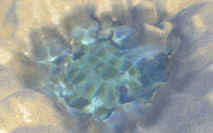 A close-up of rippling water reflecting blue and green light, viewed through an irregular opening in wet sand.