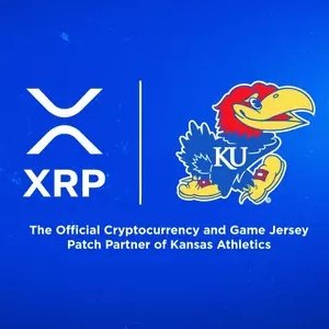 The image shows a blue graphic featuring the XRP logo alongside the University of Kansas Jayhawk mascot, with text reading "XRP" and "The Official Cryptocurrency and Game Jersey Patch Partner of Kansas Athletics," highlighting the historic partnership where XRP becomes the first cryptocurrency to be featured on a major U.S. college sports team's jersey.