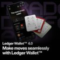 The image features a cell phone with an app displayed that appears to be related to Ledger Wallet technology. The app has a purple background and white text, which reads "The first wallet you can make moves seamlessly with Ledger Wallet". The phone is placed on top of a black surface, and there are three small objects in the image: two red cards and one white card.

The post also includes some text that says "gm from the metaverse fortress secure your world your keys,your rules, your @Ledger". This suggests that the app might be related to Ledger Wallet technology or a similar concept, as it is designed for users to securely store their digital assets and manage their finances.