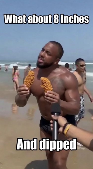 A meme photo of a muscular man on a beach holding two fried chicken strips, with text reading "What about 8 inches" at the top and "And dipped" at the bottom.