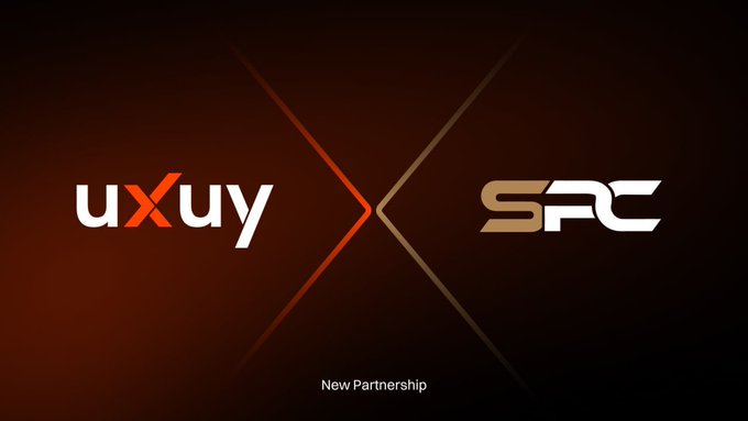 The image features two logos, one for "SXUY" (a company) and another for "SUPERCAR_SPC" (an organization). The text below the logos reads "Welcome @SUPERCAR_SPC to the @uxuycom ecosystem Let' s build a smarter future for Web3 users worldwide together".
