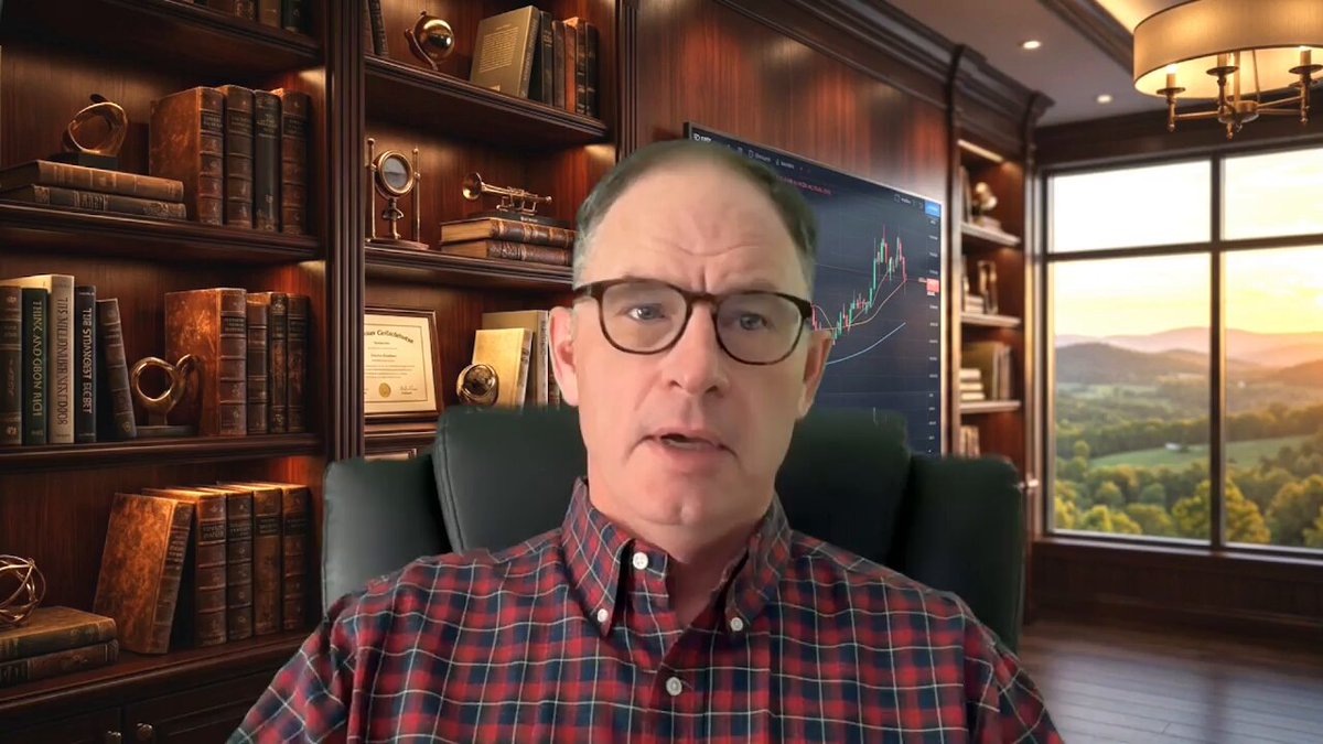 urn of gold coins sitting on a bookshelf with a window behind them, and a man wearing glasses talking into a microphone.