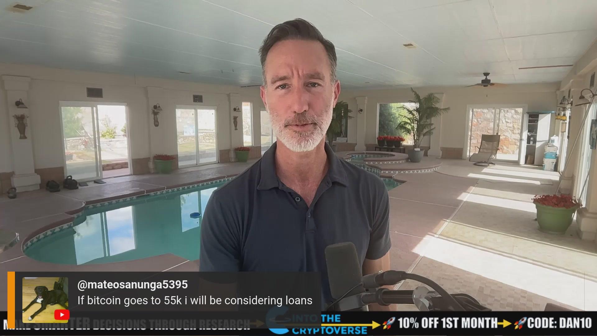 The image shows a man wearing a blue shirt holding a microphone, possibly giving a speech or interview. The background features an indoor setting with a pool area and potted plants. There are also several windows visible in the scene. The caption of the image reads "Focus on what is in the image and how it relates to the post."