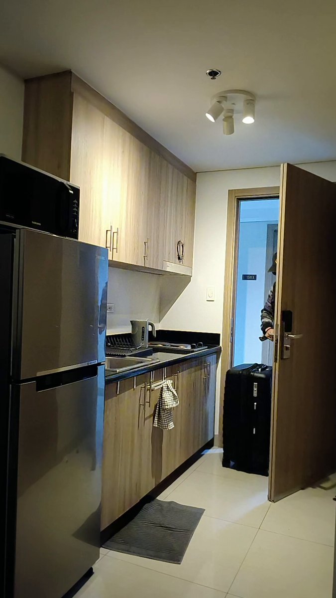 The image shows a kitchen with stainless steel appliances such as a refrigerator, microwave, oven, and sink. There are also wooden cabinets above the countertop. A suitcase can be seen placed near one of the doors, suggesting that someone might be preparing for travel or has recently returned from a trip. The post about hardware wallets emphasizes the importance of offline security measures to protect personal assets in an increasingly digital world.