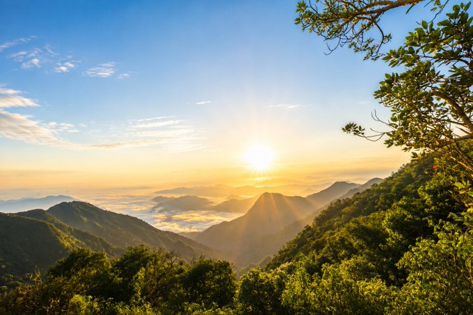 A breathtaking sunrise illuminates rolling mountain ridges above a sea of clouds, symbolizing a fresh start and steady progress—mirroring the post's message about consistent daily effort being rewarded through the Sleepagotchi $SLEEP contribution campaign.