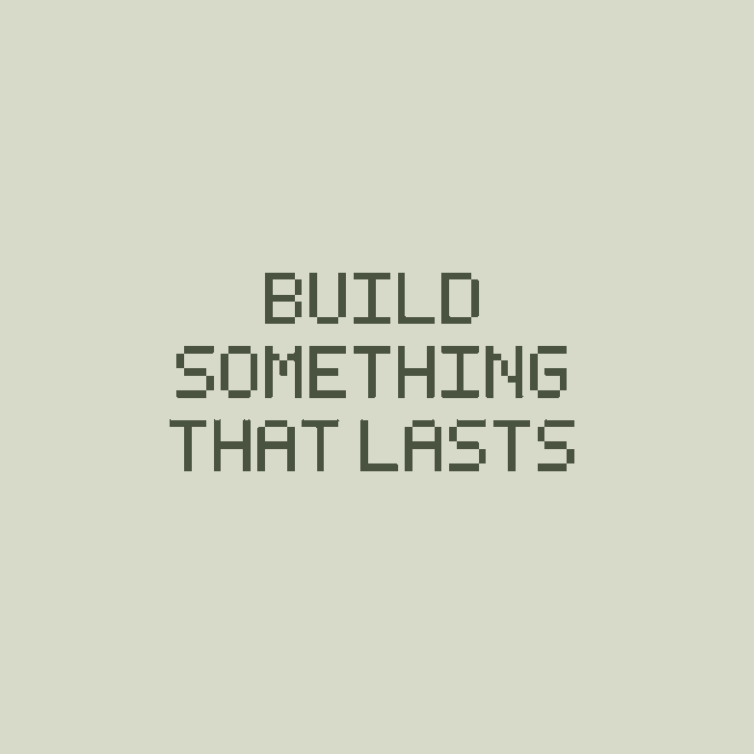 The image features a white background with black text that reads "Build Something That Lasts". The text is centered, making it easy to read. The image also includes an image of a ship sailing under a gray sky, which adds a sense of adventure or exploration to the overall theme.