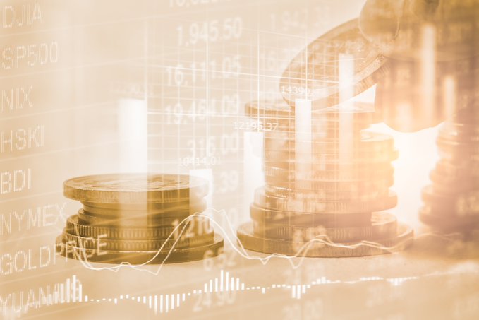 Stylized golden-tinted image showing stacks of gold coins overlaid with financial stock market data, tickers like DJIA, SP500, and GOLDP, and a rising trend line graph.