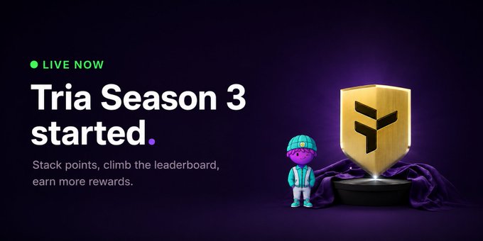 The image features a cartoon character standing next to a gold trophy, with text that reads "Live Now Tria Season 3 Started. Stalk points, climb the leaderboard, earn more rewards." The image also includes a link to a website for a cryptocurrency called Tria.
