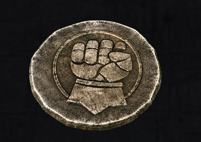 A weathered metallic medallion or seal featuring an embossed clenched fist rising from a flag or banner.