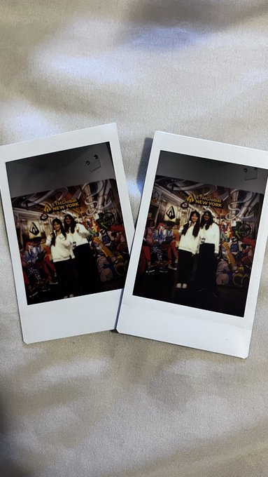 The image features two polaroid pictures of people standing next to each other, both wearing white shirts. The background appears to be a light brown color with some text visible. The caption for this image reads "My first Web3 Hackathon experience at ETHGlobal New York 2026! A special thank you to my teammate @okgopika #Web3 #Hackathon".