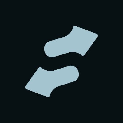 A minimalist graphic showing two light blue socks against a dark navy background.
