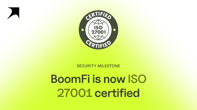 An announcement graphic with a green-to-yellow gradient background states 'SECURITY MILESTONE: BoomFi is now ISO 27001 certified,' featuring a certification badge.
