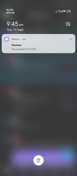 A phone notification from Phantom wallet indicating 'You received 0.618 SOL' at 9:45 pm on Tuesday, September 15.