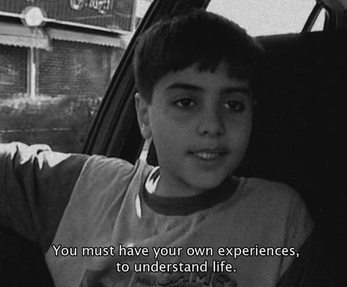 A young boy speaks from inside a car in a black-and-white frame, with the subtitle reading: "You must have your own experiences, to understand life." The reflective quote pairs naturally with the post's encouraging "Good morning champs" message, as both urge the audience to embrace their own journey and make the most of the day ahead.