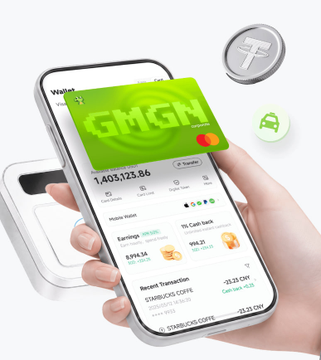 A hand holds a smartphone displaying the GMGN Cardano card interface with a balance of $1,403,123.86, showing recent transactions including a "STARBUCKS COFFEE" purchase of -$1.31 CNY and earnings of 575.21 MUMU tokens, while a physical card and floating T cryptocurrency coin appear in the background—visually illustrating the post's announcement of the GMGN CARD's launch for spending meme coin earnings directly without withdrawal.
