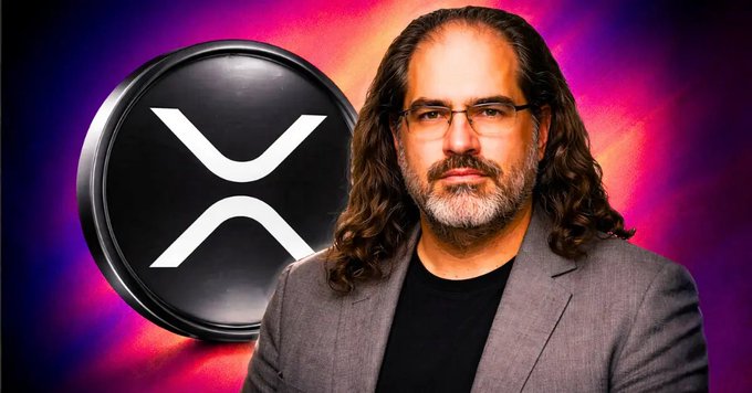 A man with long dark hair, glasses, and a gray blazer stands beside a large black XRP logo coin, set against a vibrant purple and pink background. The image accompanies news about the XPUMP presale launching on the XRP Ledger, evoking Arthur Britto's long-term vision for XRP reaching $10,000.