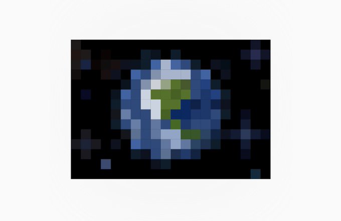 A pixelated, low-resolution image showing a circular object with blue and green colors against a dark background.