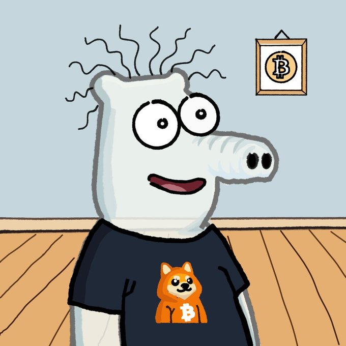A cartoon crocodile character with squiggly lines above its head wears a black t-shirt featuring an orange dog with the Bitcoin 'B' symbol, while a framed Bitcoin logo hangs on the wall behind it.