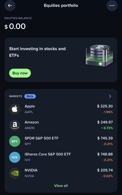 A mobile screenshot of an "Equities portfolio" on Uphold showing a $0.00 balance with a "Buy now" prompt and a Beta markets list featuring Apple (AAPL) at $325.30, Amazon (AMZN) at $249.97, SPDR S&P 500 ETF (SPY) at $745.39, iShares Core S&P 500 ETF (IVV) at $748.88, and NVIDIA (NVDA) at $205.74. The image illustrates Uphold's new feature allowing users to trade stocks and ETFs like Apple and SPY alongside crypto within the same app.