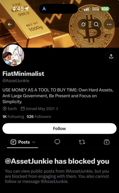 The image shows a blocked message from "@AssetJunkie" on the "FiatMinimalist" profile page, with 1K Following and 526 Followers, featuring gold bars and Bitcoin in the header. The caption reveals the user was blocked after promoting Zcash, as the account holder prefers Bitcoin, illustrating the crypto tribal rivalry referenced in the post.