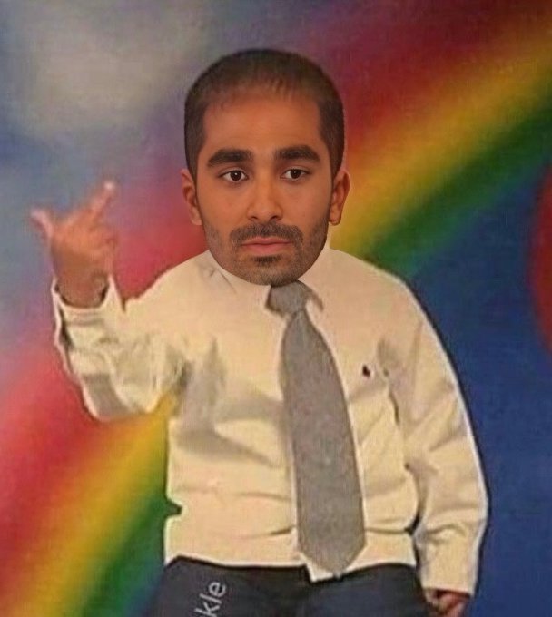 A young man in a white dress shirt and gray tie sits centered against a colorful rainbow-streaked background, his right hand raised behind his head showing what appears to be a gesture, directly identifying himself as the person running the account.