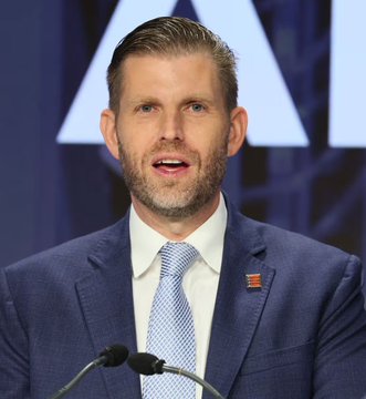 Eric Trump, son of President Donald Trump, speaks at a podium with an American flag pin on his lapel, pictured in connection with a post claiming he commented on the sharp rise of $ETH (Ethereum) and endorsed cryptocurrency as "the future."