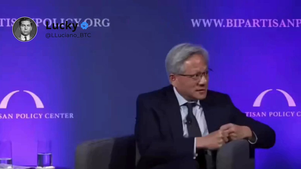 The image shows a man sitting at a table, wearing glasses and a suit jacket. The background features a blue wall with two white arches displaying the words "SANDPOLICYcenter" and "Bipartisan". There are also several cups placed on the table in front of him. The post is titled "Turning power into knowledge: How the mechanics behind Bitcoin mining are layout out the perfect blueprint for the future of AI."