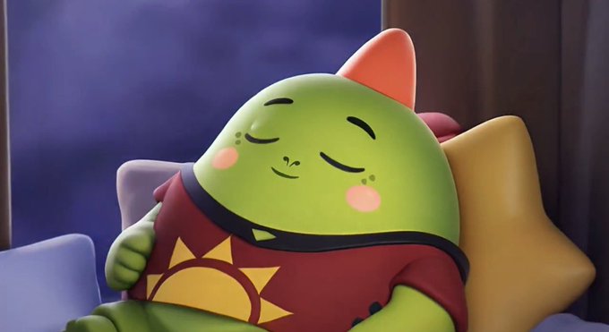 A 3D-rendered, cartoon-style green cat character with a pink ear is shown peacefully sleeping against a yellow star-shaped pillow, wearing a red shirt with a sun design.