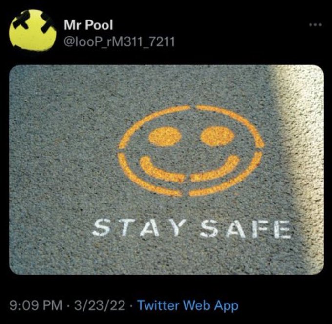 A Twitter screenshot from 'Mr Pool' (@looP_rM311_7211) dated 3/23/22 at 9:09 PM, showing a painted smiley face on asphalt with the white text 'STAY SAFE' below it.