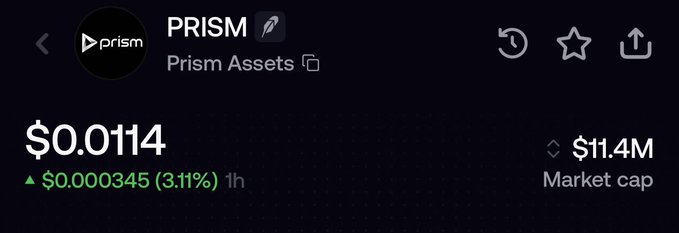 A CoinGecko price tracker for the PRISM token (Prism Assets) shows a current price of $0.0114, up $0.000345 (3.11%) over the past hour, with a market cap of $11.4M. The modest single-hour gain and small market cap contextualize the post's celebration of holding through a -90% drawdown to new ATHs, framing the $0.0114 price point as a recovery milestone rather than the previously anticipated $10 target.