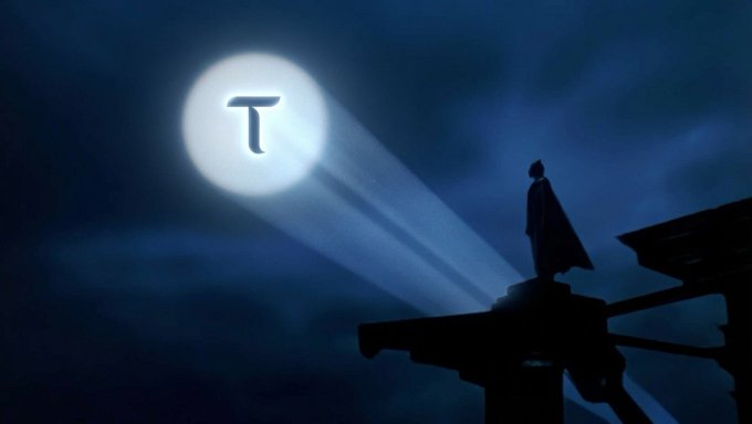 Dark silhouette of a caped figure standing on a wooden structure at night, with a glowing moon bearing a 'T' symbol illuminating the sky.