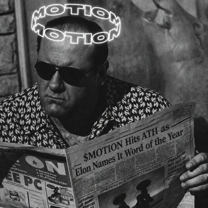 A stylized black-and-white image of a man in sunglasses reading a newspaper with the headline '$MOTION Hits ATH as Elon Names It Word of the Year', with the glowing text 'MOTION MOTION' hovering above him.