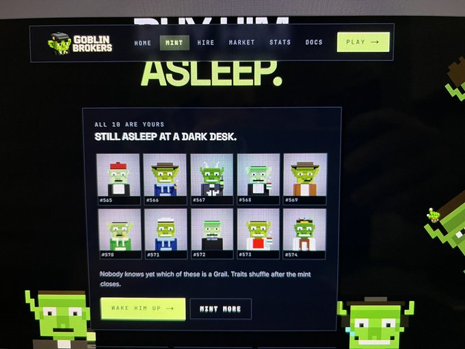 A screenshot from a 'Goblin Brokers' NFT minting website, showing pixelated goblin characters 'still asleep at a dark desk' with options to 'wake him up' or 'mint more'.
