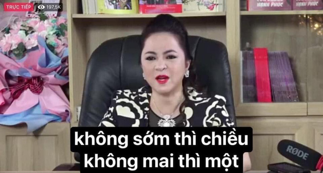 A video screenshot featuring a Vietnamese woman speaking in an office setting, with Vietnamese text overlay reading 'không sớm thì chiều không mai thì một' and 197.5K live viewers.