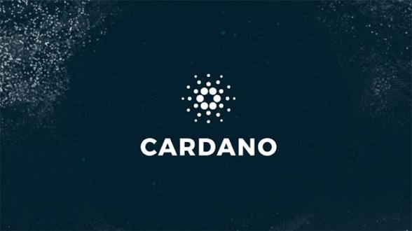 The image shows the Cardano logo and brand name displayed on a dark background with a subtle particle effect, visually reinforcing the post's announcement about Petrobras piloting Cardano blockchain technology for two lower-carbon fuel initiatives.