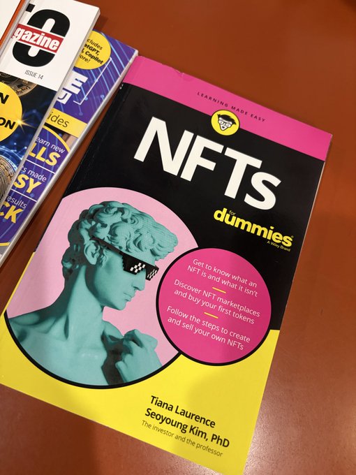A pink and yellow "NFTs For Dummies" book by Tiana Laurence and Seoyoung Kim, PhD, featuring a classical bust statue wearing pixelated "deal with it" sunglasses, with bullet points about understanding NFTs, discovering marketplaces, and creating your own NFTs.
