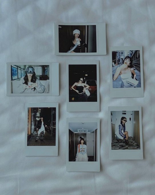 Seven Polaroid-style instant photographs are arranged on a white fabric surface, each depicting a woman in various fashion-forward poses and outfits, including street-style shots and indoor portraits.

In the bottom center photo, an "EXIT" sign is visible above a doorway.