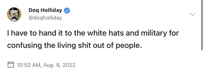 The image shows a tweet from Dog Holliday (@doqholliday) posted at 10:52 AM on August 8, 2022, reading "I have to hand it to the white hats and military for confusing the living shit out of people." The tweet complements the cryptic post's theme of hidden agendas and "silence is golden" messaging by attributing confusion to behind-the-scenes white hat/military actions, reinforcing the conspiratorial tone of the accompanying text about march orders and a "gift at the end."