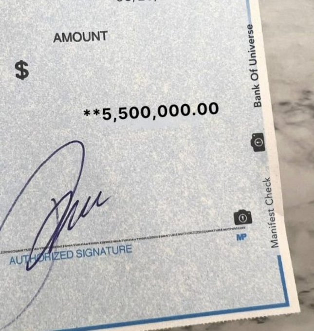 A close-up of a check from "Bank Of Universe" with the amount "**5,500,000.00" written, signed with a blue pen above the "AUTHORIZED SIGNATURE" line.