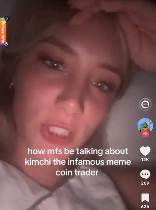 A TikTok video screenshot of a young woman with the caption 'how mfs be talking about kimchi the infamous meme coin trader', showing 12K likes.
