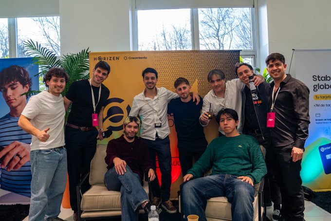 A group of young men pose together at an event in front of a 'HORIZEN' and 'Createland' branded backdrop.