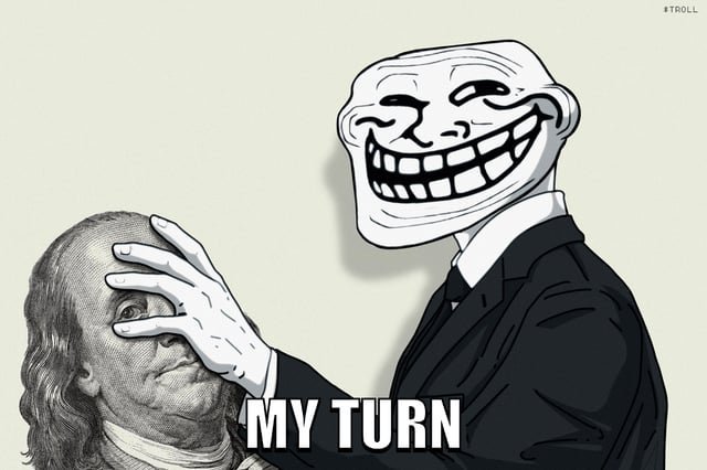 A troll face meme depicting a suited figure covering Benjamin Franklin's face with the text 'MY TURN.'