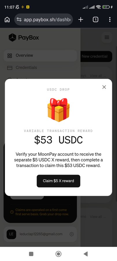 A mobile browser screenshot of the PayBox app showing a 'USDC DROP' popup offering a $53 USDC variable transaction reward, requiring MoonPay verification and a transaction to claim.