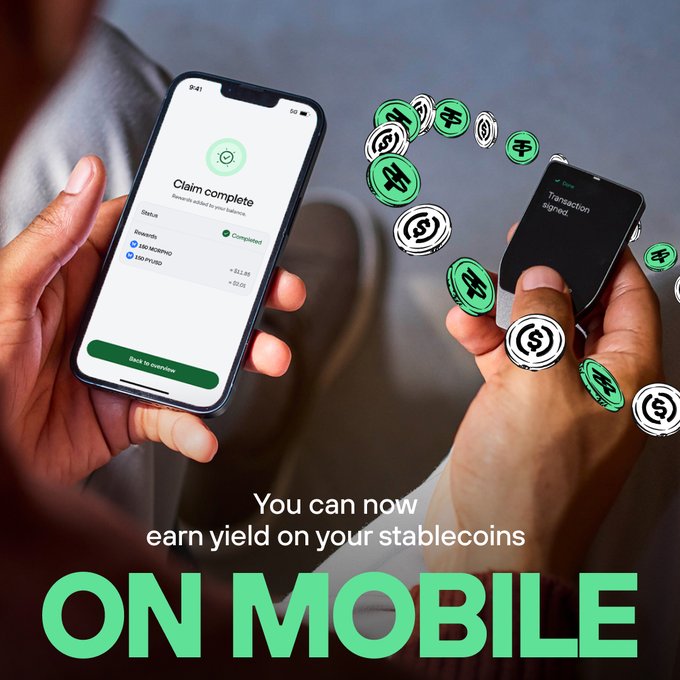 A promotional image showing two hands holding smartphones with stablecoin transaction screens, accompanied by green coin graphics and text reading 'You can now earn yield on your stablecoins ON MOBILE'.